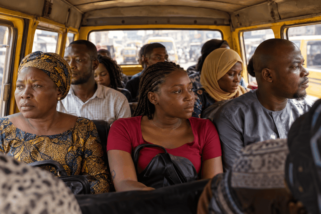 Why Are My Inner Thighs Dark? What Is Really Going On 2 Passengers sitting inside a crowded yellow transit van, their skin showing areas of hyperpigmentation.